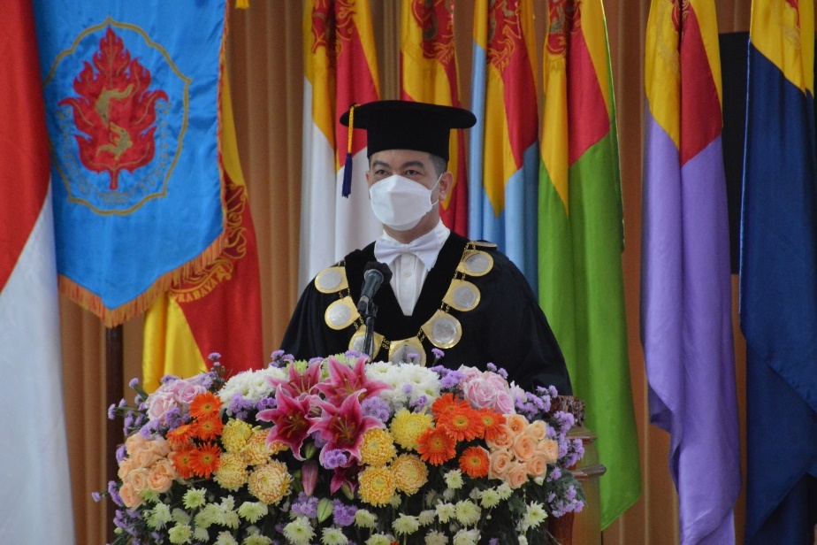 A person in a uniform surrounded by flowers and flags

Description automatically generated with low confidence